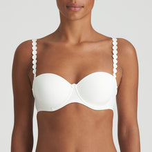 Load image into Gallery viewer, Ivory strapless balconnet underwired bra. The shoulder straps have a playful circular design which can be converted into a halter style. The formed smooth finish of the cup is perfect under T/Shirts. Perfect for strapless or normal wear. Fabric Content: Polyamide: 39%, Polyester: 35%, Elastane: 26%