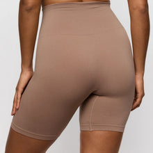 Load image into Gallery viewer, Brown bike shorts worn by a person on a plain background