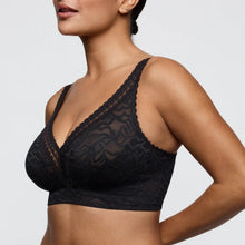 Load image into Gallery viewer, Black lace bra worn by a model on a light gray background