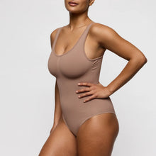 Load image into Gallery viewer, Woman wearing a beige bodysuit against a plain background