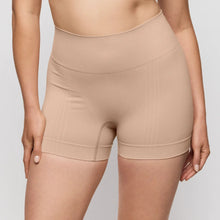 Load image into Gallery viewer, Beige shapewear shorts worn by a person on a plain background