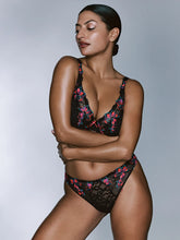Load image into Gallery viewer, Woman wearing a black floral lingerie set against a gray background