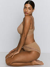Load image into Gallery viewer, Woman wearing a beige bra and panties set on a white background