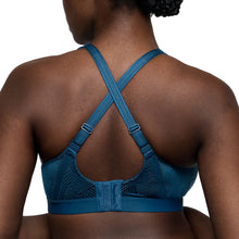 Load image into Gallery viewer, Blue sports bra worn by a person on a white background