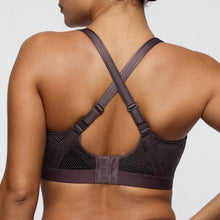 Load image into Gallery viewer, Black sports bra with criss-cross straps on a neutral background