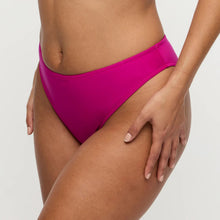 Load image into Gallery viewer, Person wearing bright pink high-waisted bikini bottoms on a light gray background