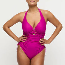 Load image into Gallery viewer, Woman wearing a bright pink swimsuit with a gold buckle on a light gray background