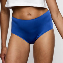 Load image into Gallery viewer, Person wearing blue high-waisted bikini bottoms on a plain background