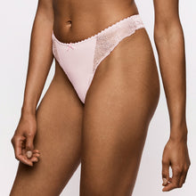 Load image into Gallery viewer, A close-up of a model wearing light pink lace-trimmed bikini-style underwear against a plain light background.