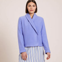 Load image into Gallery viewer, Azure. Soft fleece wrapover long sleeved bedjacket. It closes with a single Corozo button. The shawl collar and curved front detail add the final touches of style to this soft, light and cosy bedjacket. Made in Portugal. Available in Azur Blue Composition: 70% Polyester, 30% Viscose. Machine Washable.
