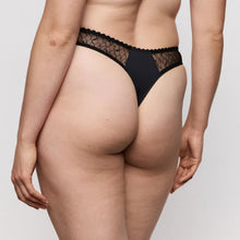 Load image into Gallery viewer, Person wearing black lace underwear on a plain background