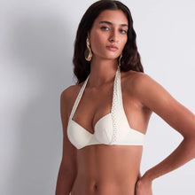 Load image into Gallery viewer, This stunning Simmer Stars formed plunge bikini top by Aubade showcases an elegant cream design enhanced by a double row of gleaming golden studs. The halter neck is a timeless classic that offers a flattering shape.
The lightly moulded cup on the top is underwired for additional support and light padding ensures a comfortable fuller fit.
This is a refined choice for those seeking both style and empowerment in their swimwear collection.