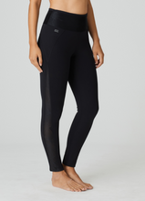 Load image into Gallery viewer, Workout pants in dry-fit fabric to ankle length. They have transparent inserts at the sides. These have an elegant, figured shape and come up to the waist. There is a small pocket on to the back handy for carrying small items when out running. <br>Fabric Content: Polyamide: 81%, Elastane:19%