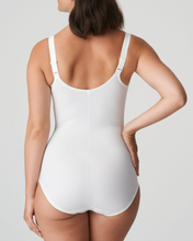 Load image into Gallery viewer, A luxurious figure-fixing body with three-section underwire, finished with abundant embroidery on cups, straps, leg openings and front section. The firm cups give an excellent lift while the side sections on the cups nudge the bust towards the centre. The cups also are deeper than any other Prima Donna bra, which ensures better uplift for largest sizes. The central section of the body smoothes away lumps and bumps on tummy and waist, creating a flowing figure. Ivory.
