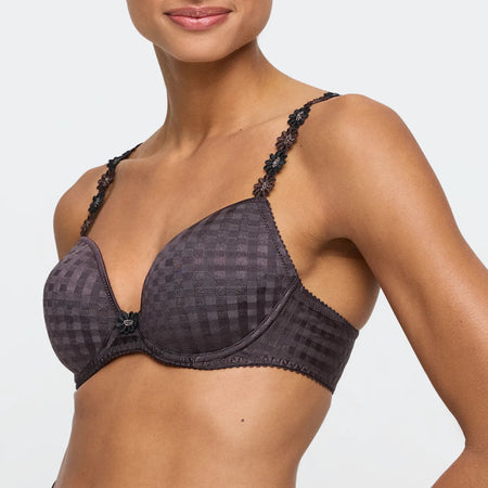 Black patterned bra worn by a model on a light gray background
