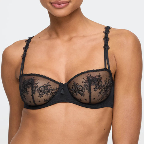 Black lace bra worn by a model on a plain background