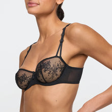 Load image into Gallery viewer, Black lace bra worn by a model on a plain background
