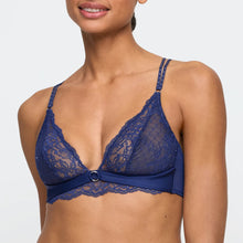 Load image into Gallery viewer, Blue lace bra worn by a model on a white background
