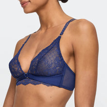 Load image into Gallery viewer, Blue lace bra worn by a model on a plain background
