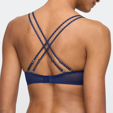 Blue bikini top with criss-cross straps on a plain background