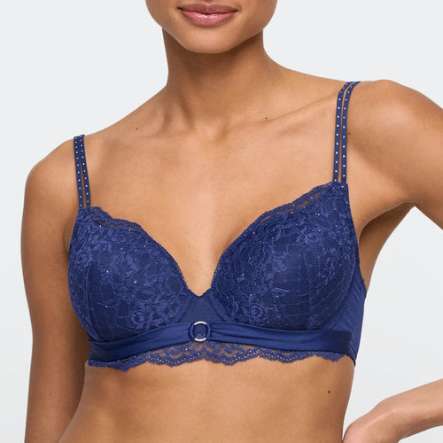 Blue lace bra worn by a model on a white background