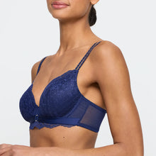 Load image into Gallery viewer, Navy blue lace bra on a model against a plain background
