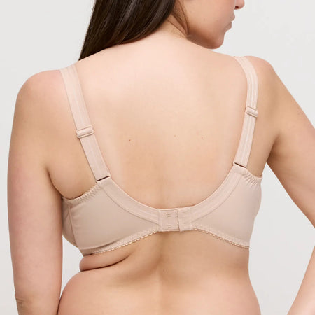 Beige bra worn by a model on a plain background