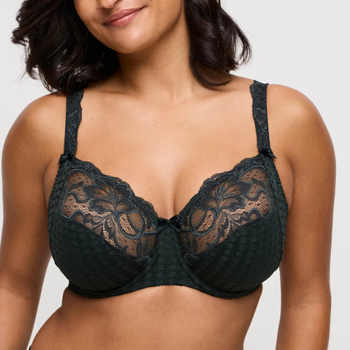 Black lace bra worn by a model on a plain background