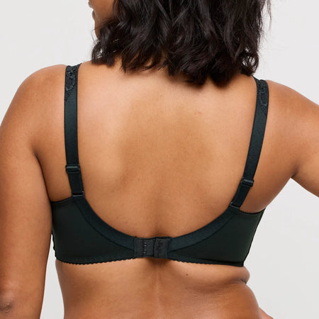green bra worn by a person on a plain background