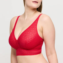 Load image into Gallery viewer, Red textured bralette worn by a model on a light gray background
