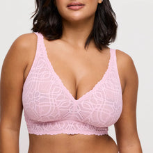 Load image into Gallery viewer, Woman wearing a pink lace bralette against a plain background
