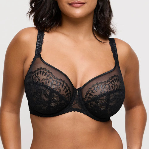 Black lace bra worn by a model on a plain background