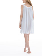 Load image into Gallery viewer, Very beautiful short (94cm) sleeveless short nightgown. Lace details on the V neck, straps and at the hem. Flared skirt for ease of movement when sleeping. Made in Germany from the finest pure Swiss cotton, Celestine nightdresses are diaphanous, offering perfect sleep without heaviness. Celestine nightwear, dressing gowns and short robes drop from the shoulder, therefore one size fits all.  Fabric composition:  100% Pure Swiss Cotton. 100% Guipure Cotton Lace. Machine Washable. Azure.
