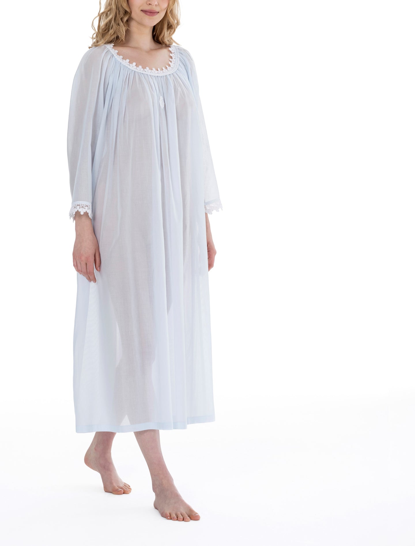 Azure Full Length (126cm) long sleeve nightgown. Lace details on gently rounded neckline and sleeve cuff. Flared skirt for ease of movement when sleeping. Made in Germany from the finest pure Swiss cotton, Celestine nightdresses are diaphanous, offering perfect sleep without heaviness. Celestine nightwear, dressing gowns and short robes drop from the shoulder, therefore one size fits all.  Fabric composition:  100% Pure Swiss Cotton. 100% Guipure Cotton Lace. Machine Washable.