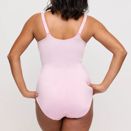 Person wearing a pink swimsuit against a plain background