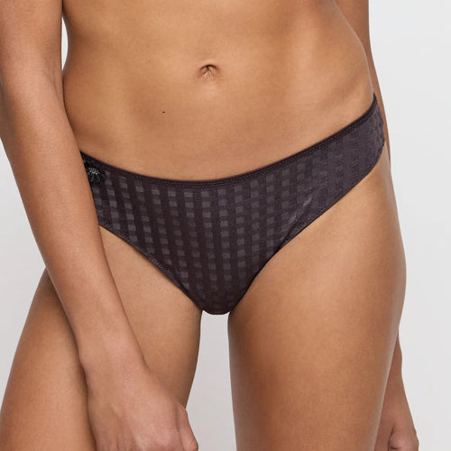 Black patterned underwear worn by a person on a plain background
