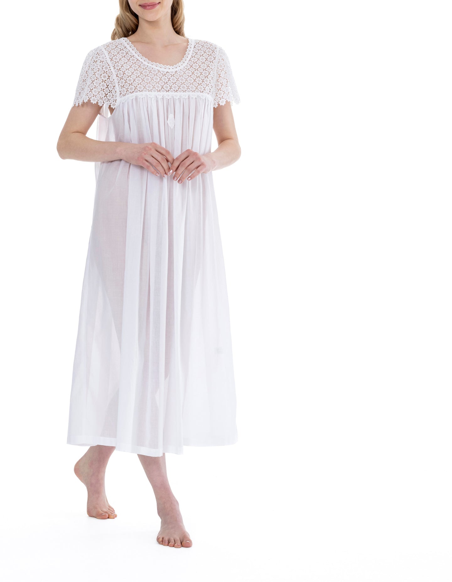 White Full Length (126cm) short sleeve nightgown. Heavy lace throughout the bodice. on the gently rounded neckline and short sleeve. Flared skirt for ease of movement when sleeping. Made in Germany from the finest pure Swiss cotton, Celestine nightdresses are diaphanous, offering perfect sleep without heaviness. Celestine nightwear, dressing gowns and short robes drop from the shoulder, therefore one size fits all.  Fabric composition:  100% Pure Swiss Cotton. 100% Guipure Cotton Lace. Machine Washable.