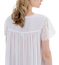 Load image into Gallery viewer, White Full Length (126cm) short sleeve nightgown. Heavy lace throughout the bodice. on the gently rounded neckline and short sleeve. Flared skirt for ease of movement when sleeping. Made in Germany from the finest pure Swiss cotton, Celestine nightdresses are diaphanous, offering perfect sleep without heaviness. Celestine nightwear, dressing gowns and short robes drop from the shoulder, therefore one size fits all.  Fabric composition:  100% Pure Swiss Cotton. 100% Guipure Cotton Lace. Machine Washable.
