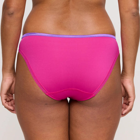 Person wearing bright pink underwear with a white background