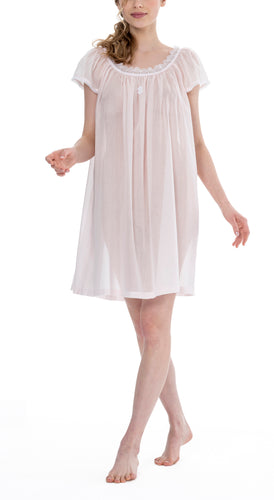 Short (93cm) short sleeve nightgown. Lace details on the gently rounded neckline and sleeve edge. Flared skirt for ease of movement when sleeping. Made in Germany from the finest pure Swiss cotton, Celestine nightdresses are diaphanous, offering perfect sleep without heaviness. Celestine nightwear, dressing gowns and short robes drop from the shoulder, therefore one size fits all.  Fabric composition:  100% Pure Swiss Cotton. 100% Guipure Lace. Machine Washable.