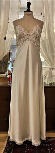 Full length, heavy weight pure silk satin nightdress. The bodice has the most beautiful and intricate lace forming several bands that run to the sides and back. Spaghetti straps, with a V neck style. The skirt is full length and cut on the bias for full movement. The lace trim at the hem completes this traditional and romantic nightgown.  100% Pure Silk Satin Made in UK. Machine washable
