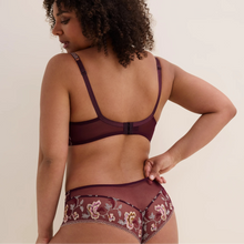 Load image into Gallery viewer, A woman shown from the back wearing a matching burgundy sheer lingerie set with floral embroidery on the high-waisted briefs, against a plain beige studio background.
