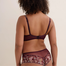 Load image into Gallery viewer, A woman with curly dark hair is shown from behind wearing a matching lingerie set. The set features a deep plum purple bra and high-waisted cheeky briefs with floral embroidery and sheer mesh, set against a plain light beige background.
