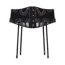 Load image into Gallery viewer, A black corset-style waist trainer with gold animal inspired embroidered patterns, gold clasps down the front, and attached black suspenders with gold hardware, shown on a plain white background.
