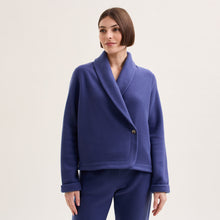 Load image into Gallery viewer, Night Blue. Soft fleece wrapover long sleeved bedjacket.  It closes with a single Corozo button. The shawl collar and curved front detail add the final touches of style to this soft, light and cosy bedjacket.   Made in Portugal. Available in Azur Blue Composition: 70% Polyester, 30% Viscose. Machine Washable.
