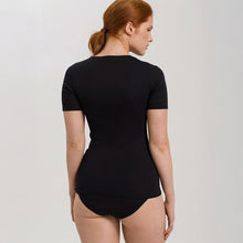 Load image into Gallery viewer, A woman wearing a black seamless cotton T-Shirt style top. It has a short sleeves and a round neck. The bottom of the shirt reaches the hips. Image of the back.
