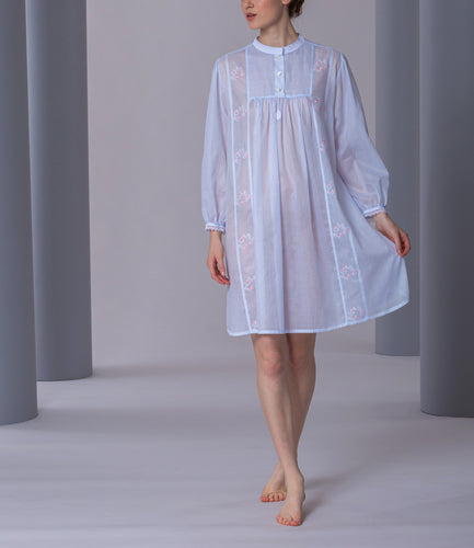 Short (95cm) long sleeve nightgown. Round high neck with button detail. Beautiful embroidery on the front, sleeves and back yoke. Narrow lace on the cuffs. Flared skirt for ease of movement when sleeping. Made in Germany from the finest pure Swiss cotton, Celestine nightdresses are diaphanous, offering perfect sleep without heaviness. Fabric composition:  100% Pure Swiss Cotton. 100% Guipure Lace. Machine Washable.