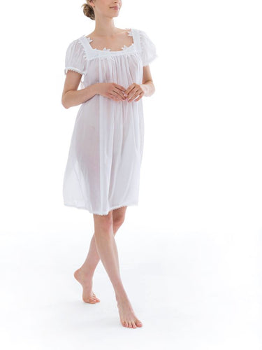 Short (98cm) short sleeve nightgown. Wide lace details on the square neckline. Narrow lace details on the short sleeve and hem edge. Flared skirt for ease of movement when sleeping. Made in Germany from the finest pure Swiss cotton, Celestine nightdresses are diaphanous, offering perfect sleep without heaviness. Celestine nightwear, dressing gowns and short robes drop from the shoulder, therefore one size fits all.  Fabric composition:  100% Pure Swiss Cotton. 100% Guipure Lace. Machine Washable.