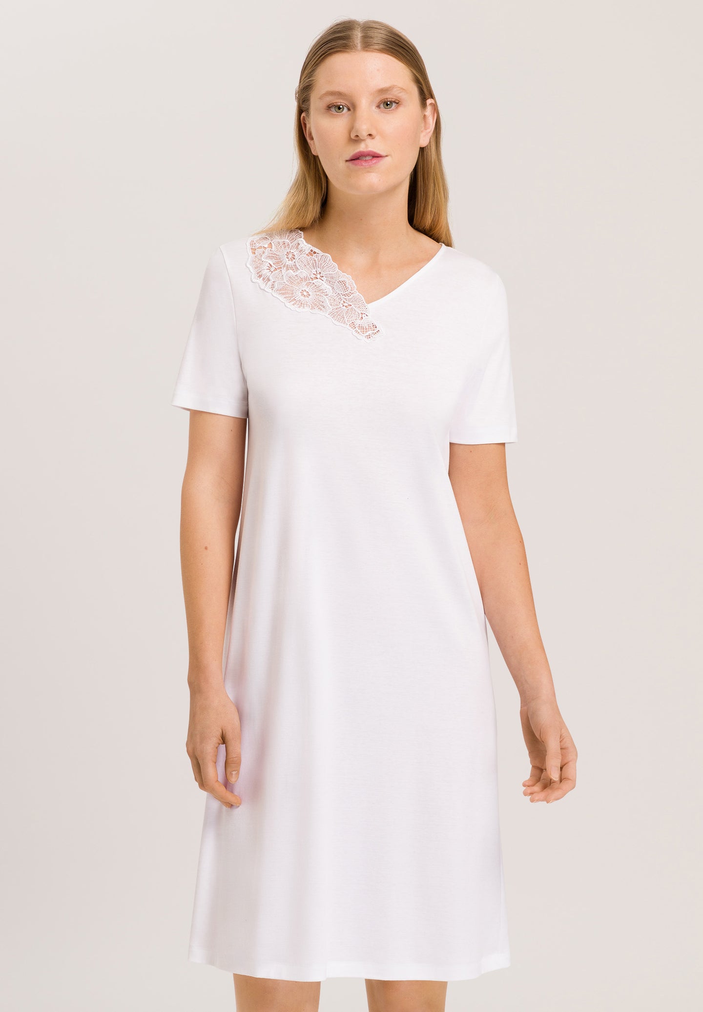 Made from 100% soft mercerised knitted cotton. Delighful asymmetric appliqué lace detail at the neckline. This is a lovely short sleeve nightgown. Deliciously comfortable for sleeping and lounging.  Length: 100cm  Composition: 100% Pure Cotton 100% Polyester Lace  Made in Europe Machine washable. Pure White.