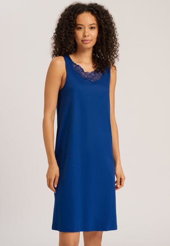 Made from 100% soft mercerised knitted cotton. This is a lovely sleeveless nightgown. Rounded lace detail at the neck. Light and airy to wear in bed.  Deliciously comfortable for sleeping and lounging.  Length: 100cm  Composition: 100% Pure Cotton 100% Polyester Lace  Made in Europe Machine washable. Indigo Blue.